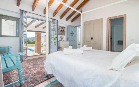 Bedroom 1 with en suite facilities and doors to patio